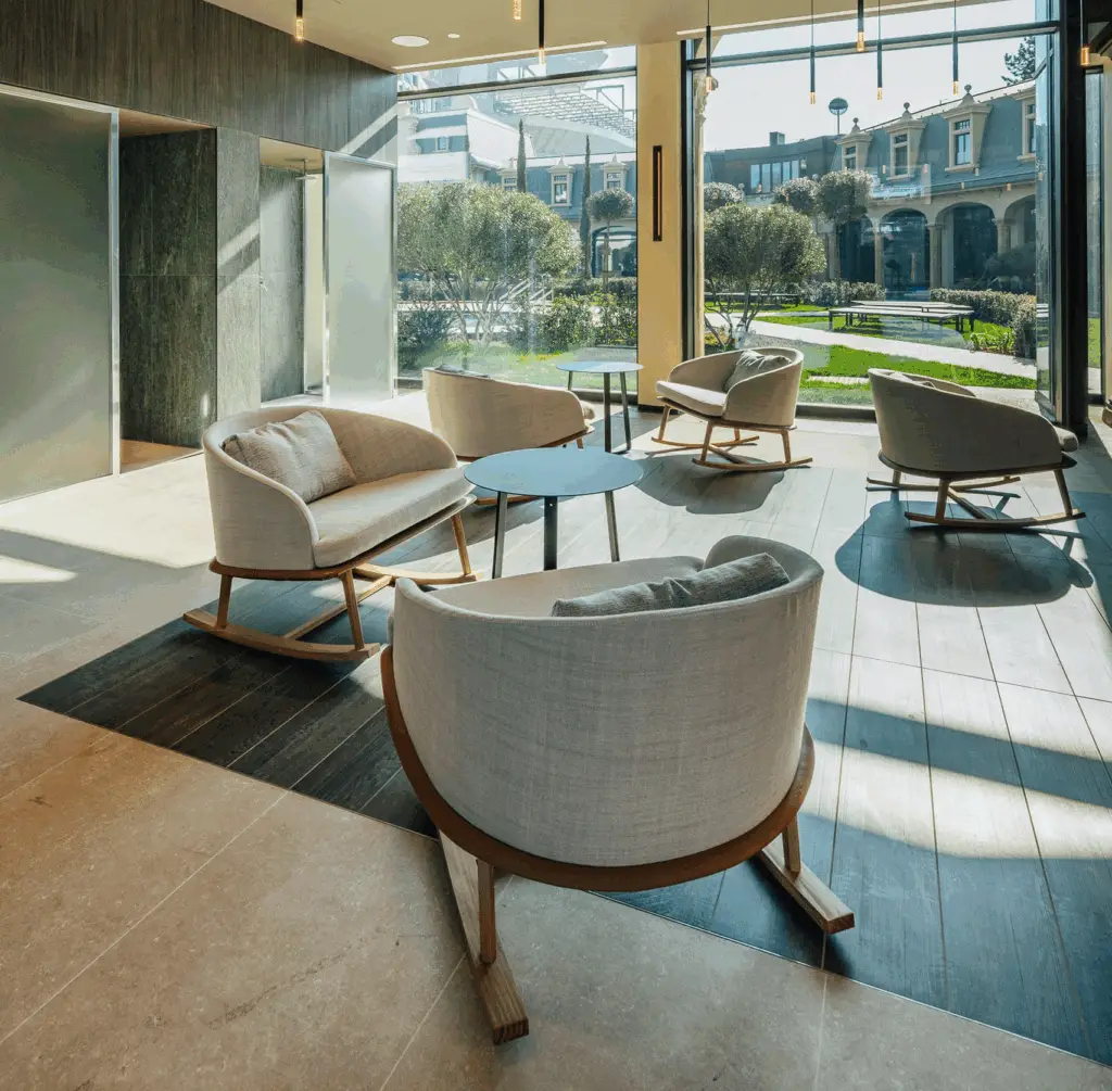 Relaxing spa waiting room with comfortable rocking chairs and natural light.